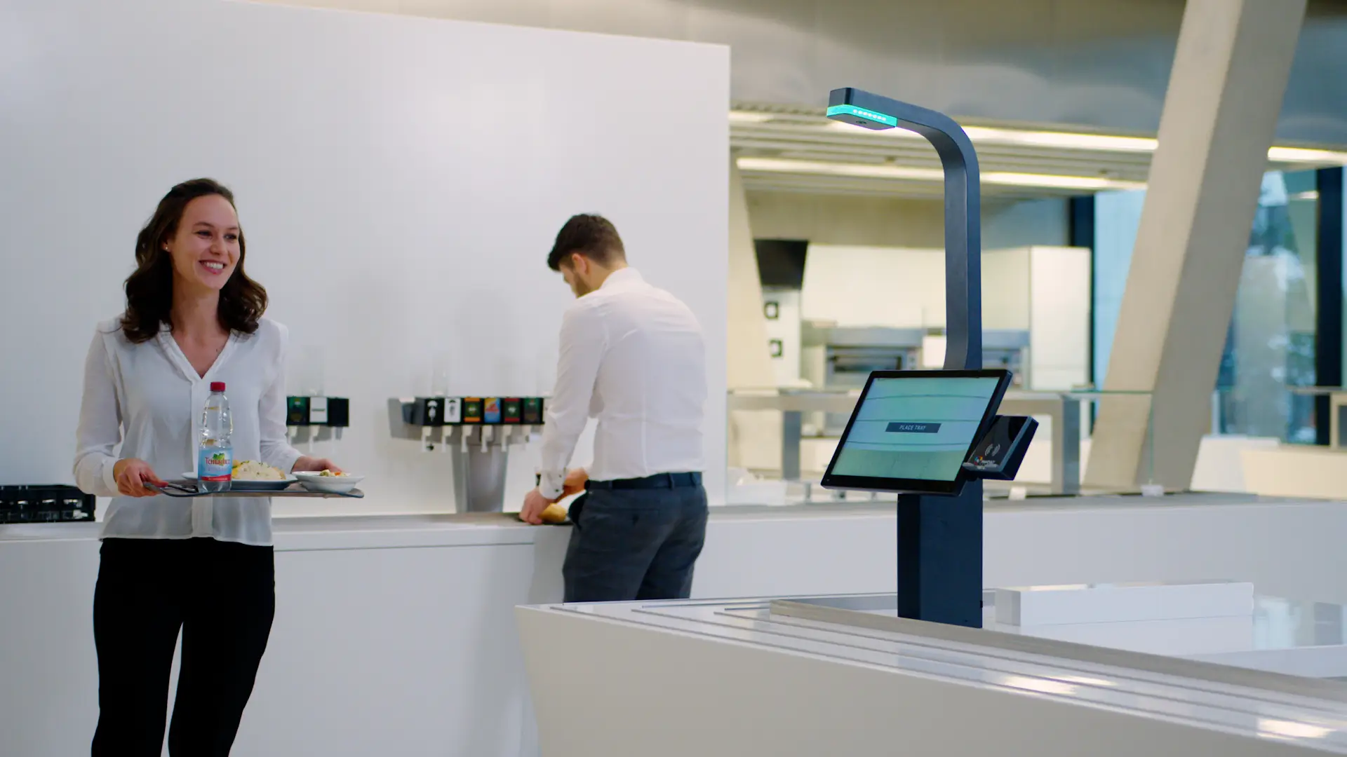 A woman using the visioncheckout system in a corporate restaurant