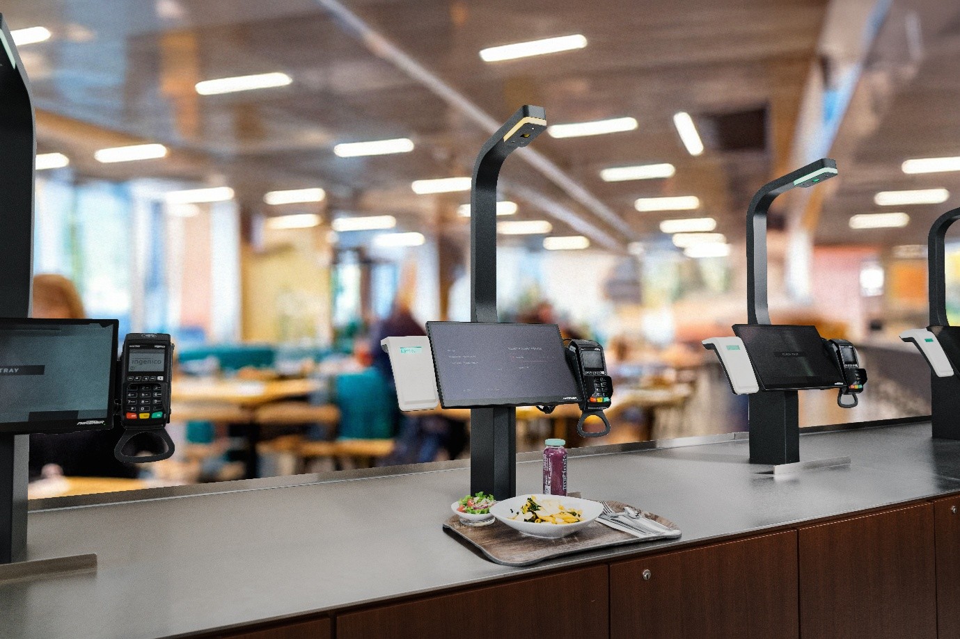 an image of 3 AI-powered visioncheckout devices on a long tabe;